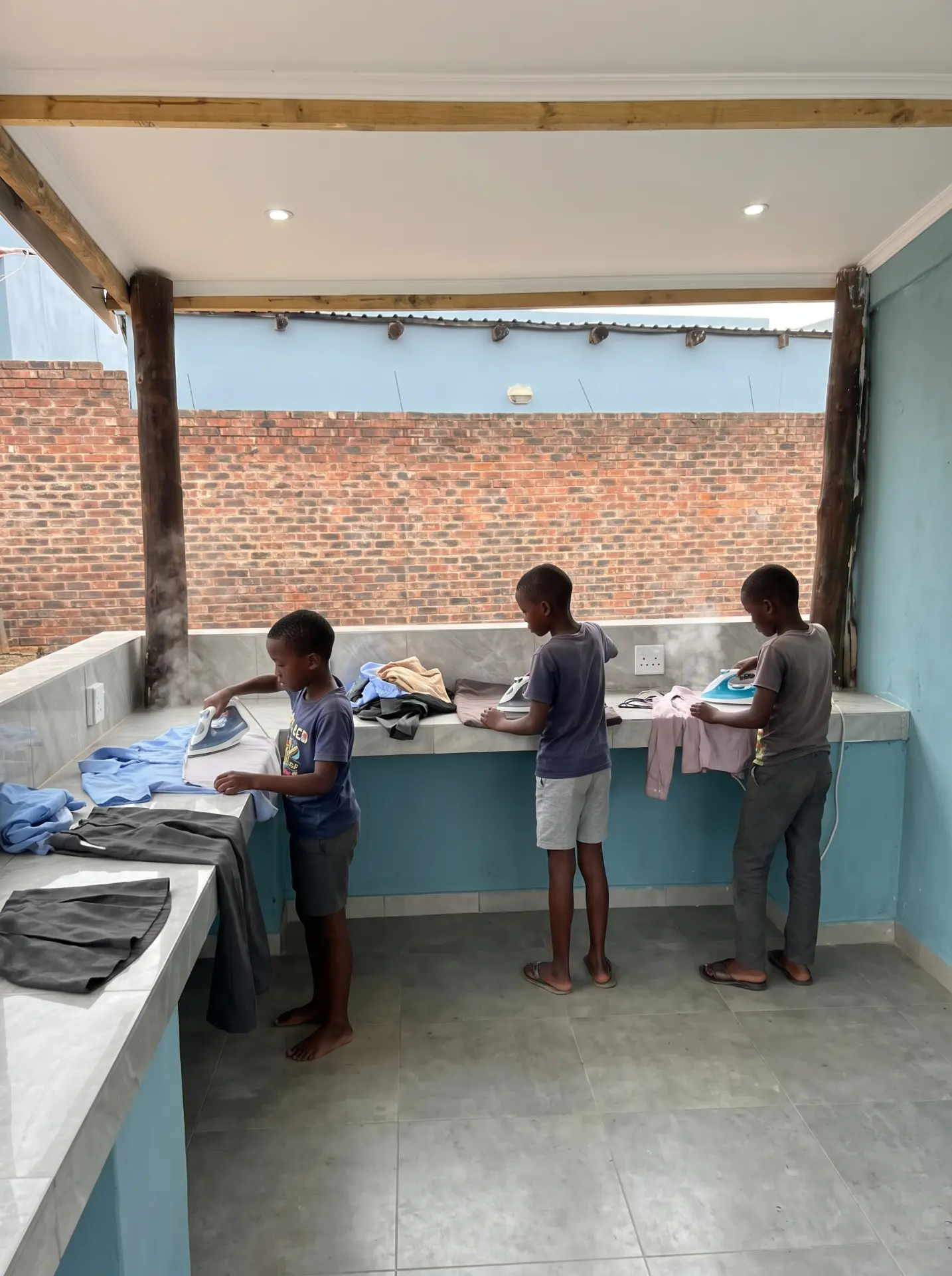 Boarders ironing their uniforms at the laundry station