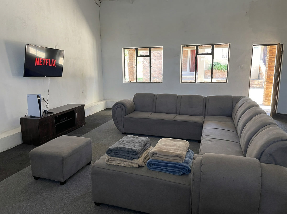Common room with comfortable seating, TV and gaming console for boarders
