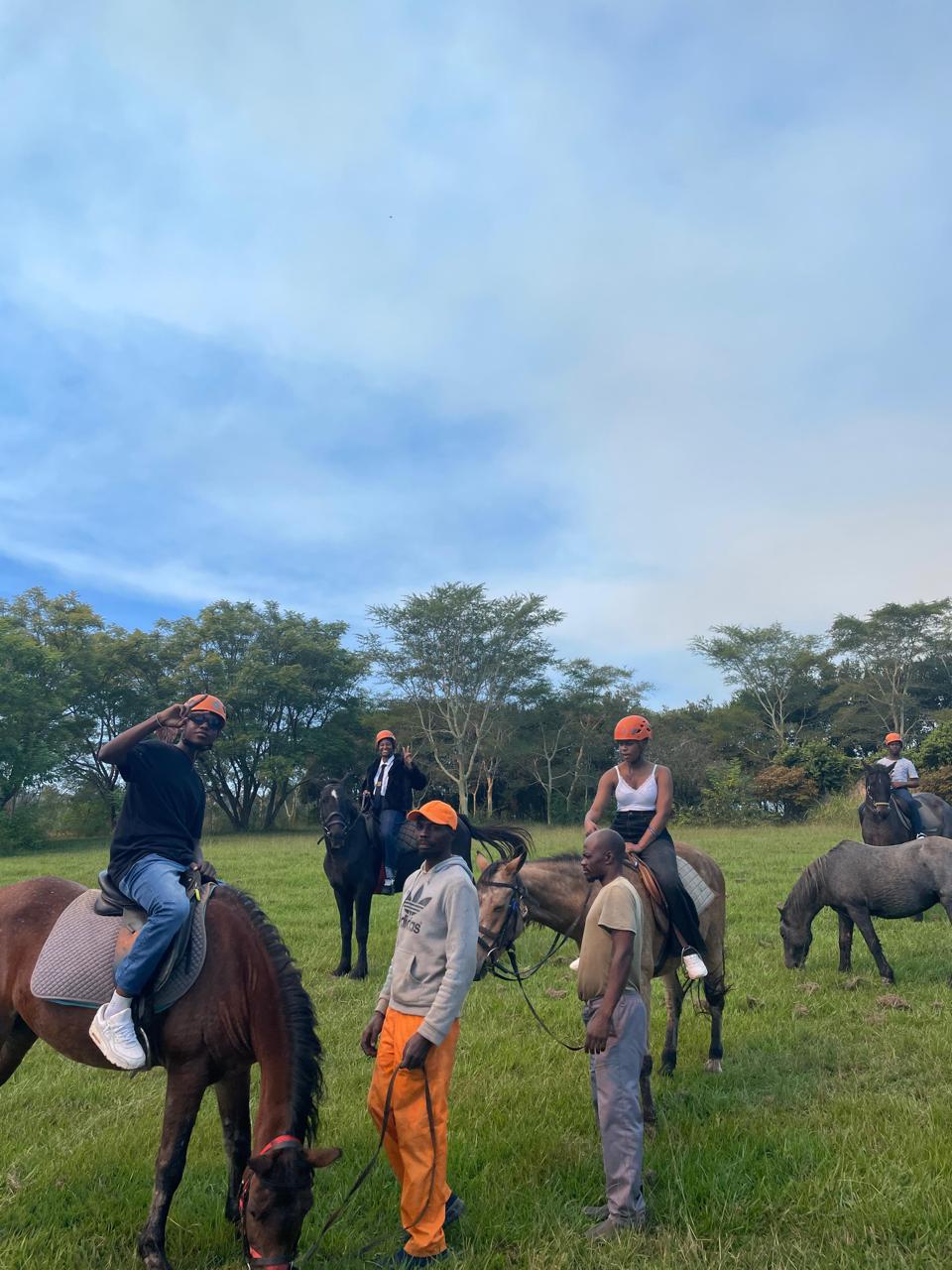 Cefups Academy learners and guides with horses on a grassy trail
