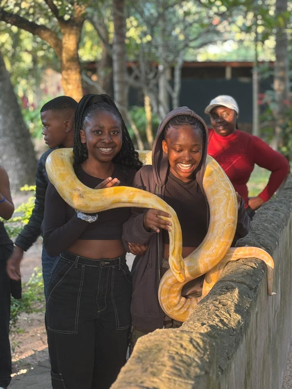Cefups Academy learners holding a python at a reptile park