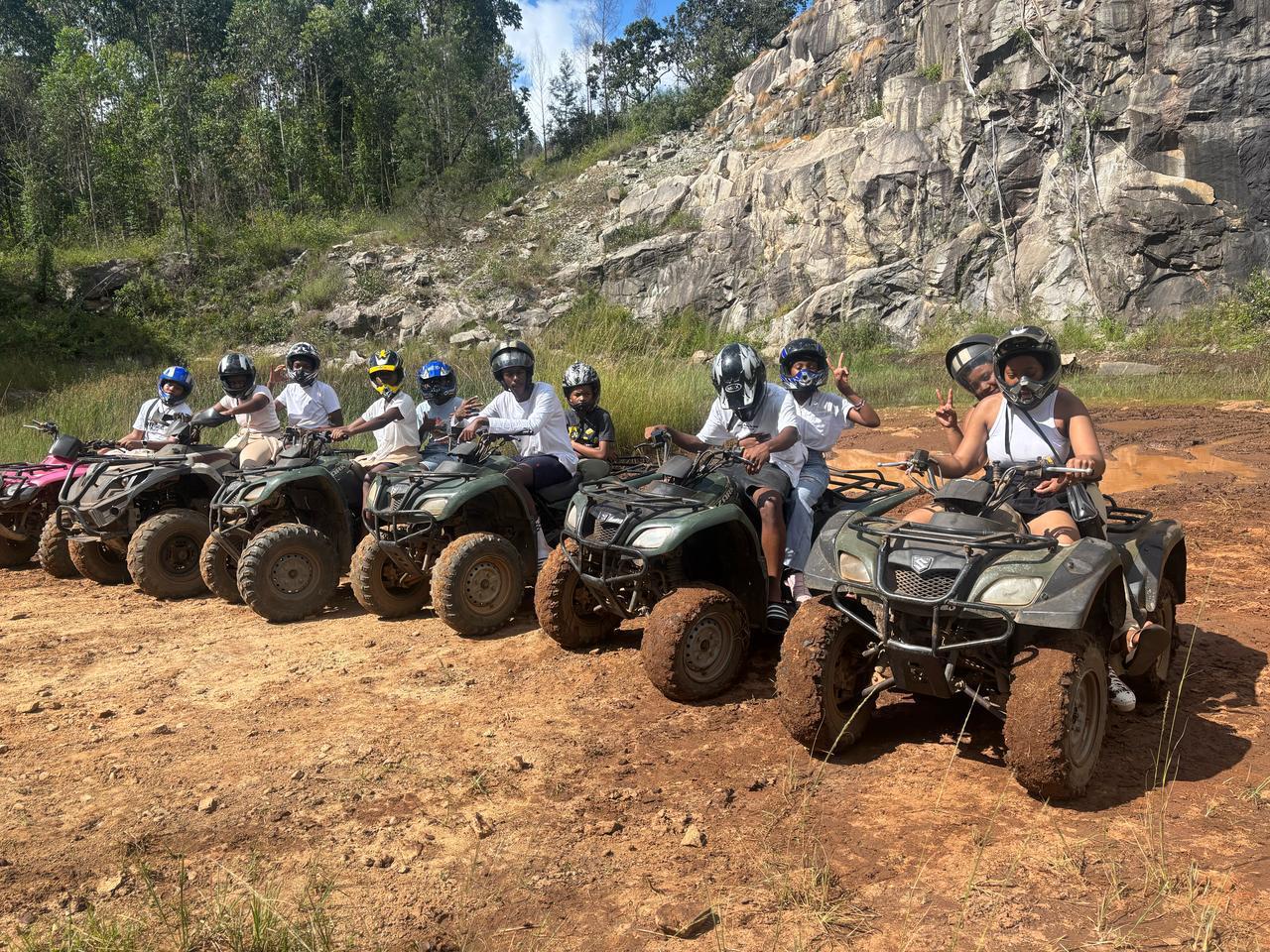Cefups Academy learners lined up on quad bikes at a quarry trail