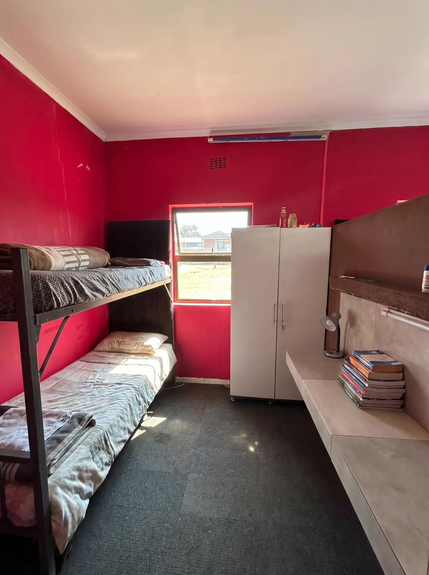Boys' bunk room with study shelf and wardrobe