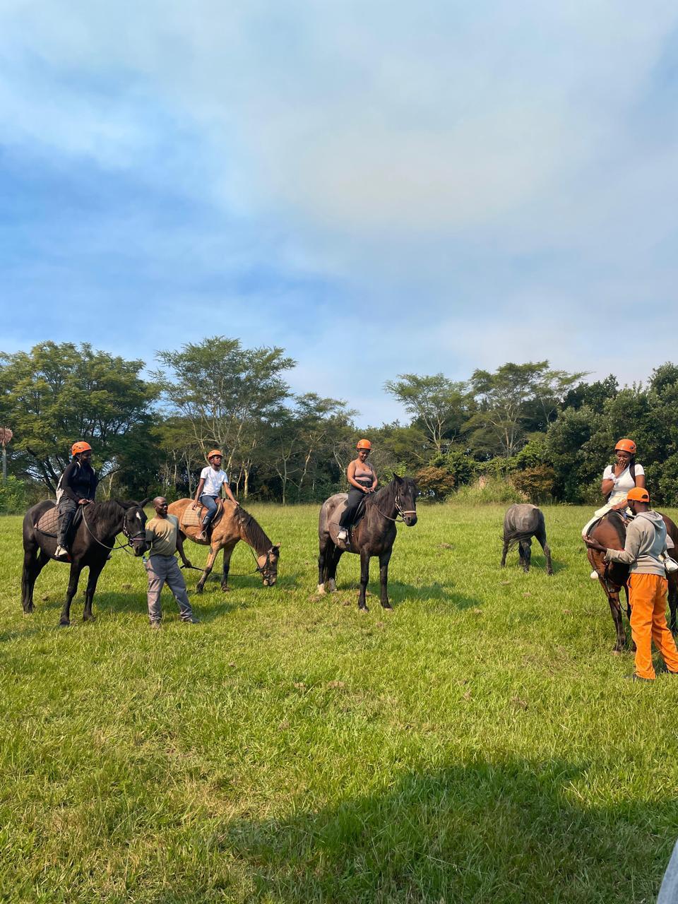 Cefups Academy learners riding horses in an open field